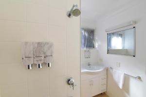 a bathroom with a sink and a mirror at Aspley Motor Inn in Brisbane
