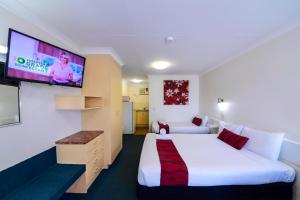 a hotel room with two beds and a television at Aspley Motor Inn in Brisbane
