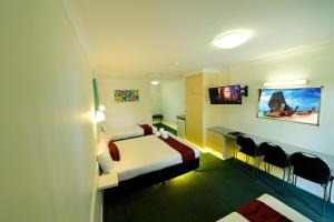 a hotel room with a bed and a tv at Aspley Motor Inn in Brisbane