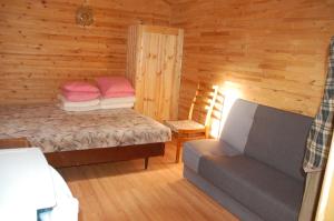 a bedroom with a bed and a couch in a cabin at Edmundas in Palanga +9 photos