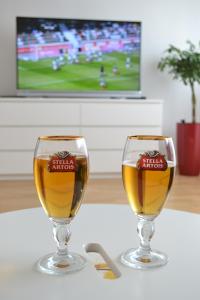 two glasses of beer sitting on a table at Fly Inn in Velika Gorica