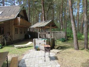a log cabin with a playground and a wooden house at Edmundas in Palanga
