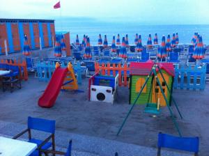 a playground with colorful play equipment on the beach at Hotel Pescetto in Albenga