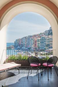 a balcony with chairs and a view of the water at Grand Hotel Portovenere in Portovenere