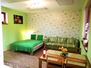 a living room with a couch and a bed at Apartman Levandula in Veľký Meder
