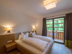 Rúm í herbergi á Das Leonhard - Naturparkhotel am Weissensee