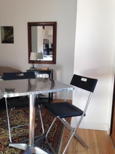 a table and two chairs in a room with a mirror at 5 rue de la Corderie in Granville