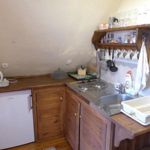 a kitchen with a sink and a counter top at Dom na Krańcu Świata in Łapicze