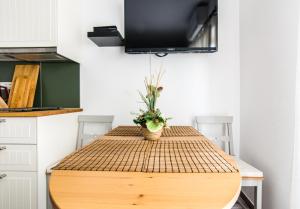 a table with a plant on top of it in a kitchen at Apartments Jankovic in Biograd na Moru