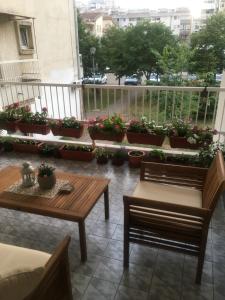 a balcony with two benches and potted plants at Apartman Zora in Bar