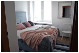 a bedroom with a bed with a stuffed animal on it at Color24 Apartament in Stalowa Wola