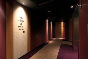 a hallway with a wall with a sign on it at Candeo Hotels Hiroshima Hatchobori in Hiroshima