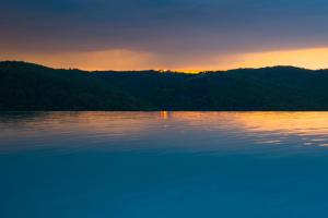 a sunset in the middle of a lake at Borgo Di Pietrafitta Relais in Castellina in Chianti