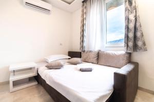 a bedroom with a large bed and a window at Apartman M.E.P. in Split