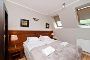 Ένα ή περισσότερα κρεβάτια σε δωμάτιο στο Apartamenty Sun & Snow Centrum