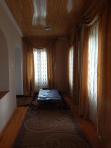 a room with a bed in front of a window at Savanna House Jvari in Jvari
