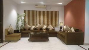 a living room with a couch and a table at Tatvam Residency in Kolkata