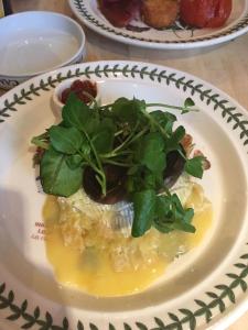 a plate of food with greens on a table at Anton Guest House Bed and Breakfast in Shrewsbury