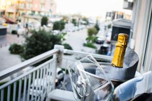 a bottle of champagne sitting on a balcony at Casa Lucia Centro Apartment Deluxe in Sottomarina