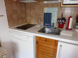 eine Küche mit einer Spüle und einer Arbeitsplatte in der Unterkunft JAUSIERS VILLAGE G 2 in Jausiers