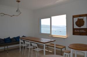 a room with a table, chairs and a window at HiTide House in Las Palmas de Gran Canaria