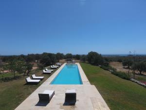 an overhead view of a swimming pool with lounge chairs at Terre Di Vendicari in Noto