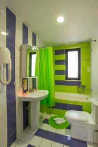 a bathroom with a sink and a toilet at Caravella Luxury Apartments in Palaiochóra +51 photos