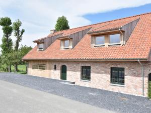 an old brick house with a red roof at Beautiful Holiday Home with Terrace Garden in Diksmuide