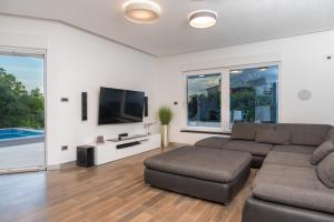a living room with a couch and a flat screen tv at Luxury apartment Shelena in Mravince