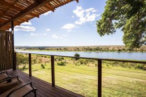 a view of a lake from the deck of a house at Buhala Lodge in Malelane