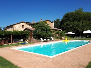 a swimming pool in front of a house at Castellare in Chiusdino