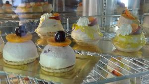 a bunch of desserts on display in a glass case at Villa Felicia in Villapiana