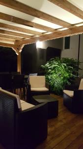 a patio with chairs and a table and a plant at Agriturismo Loghino Caselle in San Giorgio Di Mantova