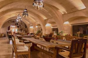 a large room with a long table and chairs at Kistar Cave Hotel in Uçhisar