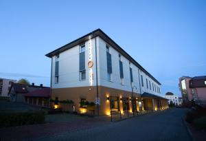 a building with a sign on the side of it at Hotel Centrum in Kwidzyn