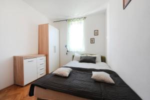 a bedroom with a bed and a dresser and a window at Olea Apartments in Srima +24 photos