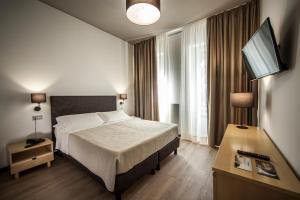 a hotel room with a bed and a television at Terme di Acquasanta Hotel Italia & Spa in Acquasanta Terme