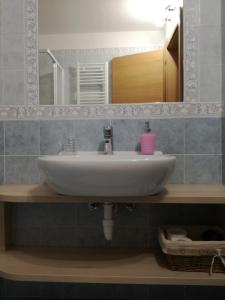a bathroom with a white sink and a mirror at B&B El Molin in Cavalese +13 photos