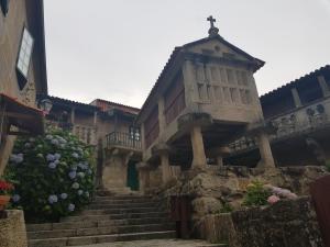 a building with stairs and a cross on top at Casa Cordieira in Combarro
