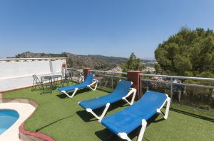 a patio with chairs and a table and a pool at Pedraviva in Ador