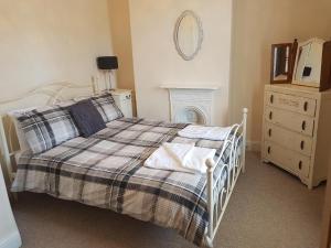 a bedroom with a bed and a dresser and a mirror at York city centre No7 Agar Street in York