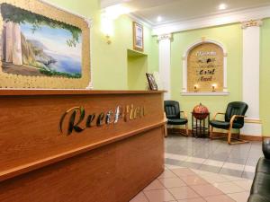 a waiting room at a salon with chairs and a counter at Hotel Mari in Saint Petersburg