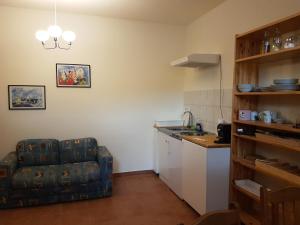 a living room with a couch and a kitchen at ARTEMIS FARM Apartment4 in Bad Blumau