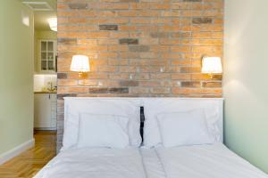 Posteľ alebo postele v izbe v ubytovaní Roland Apartments