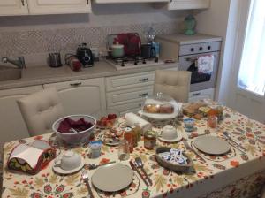 a kitchen with a table with plates and dishes on it at BFRAME Cornice Barocca in Ragusa