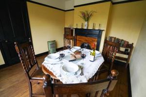 a dining room table with a white table cloth on it at The Vintage House, Aldeburgh in Aldeburgh