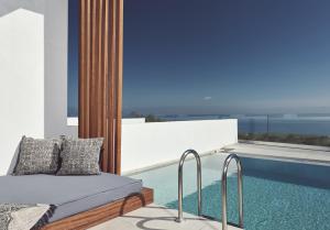 a bedroom with a bed next to a swimming pool at Hotel St.John Suites Adults Only in Tsilivi