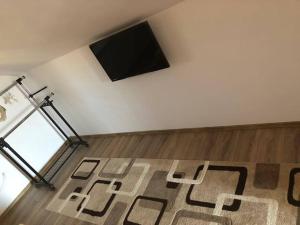 a living room with a flat screen tv on a wall at Casa Bambi in Sovata
