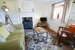 a living room with a couch and a coffee table at Hidden Cottage, Aldeburgh in Aldeburgh