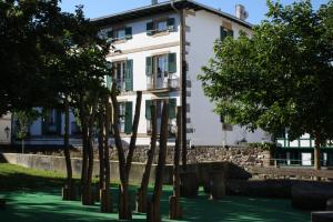 a white building with trees in front of it at Eguzkilorea in Hondarribia